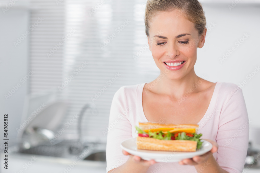 Cheerful pretty blonde with sandwich