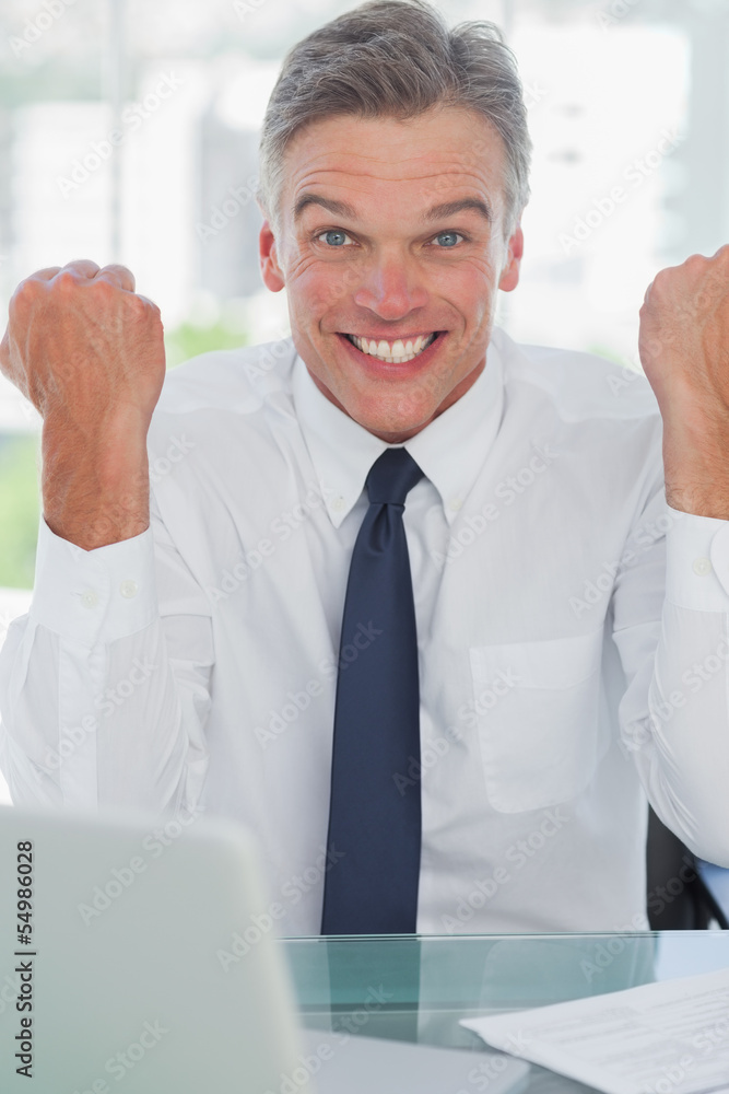 Victorious businessman cheering at camera Victorious businessman cheering at camera