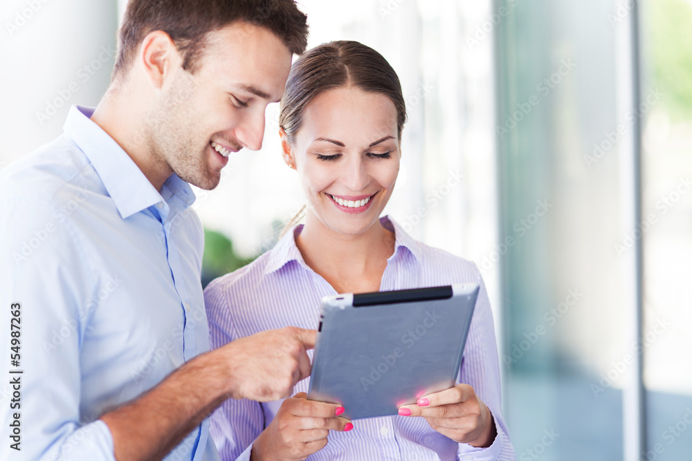 Business people using digital tablet together Business people using digital tablet together
