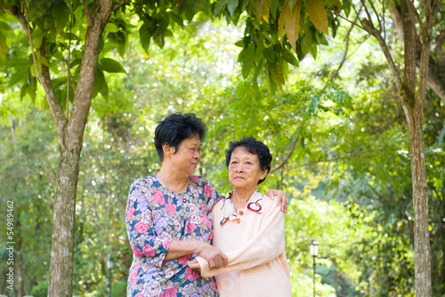 crying Asian senior mother with her senior daughter at outdoor p
