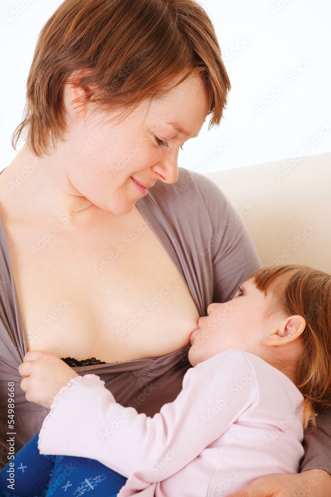 Little baby girl breast feeding. Stock Photo
