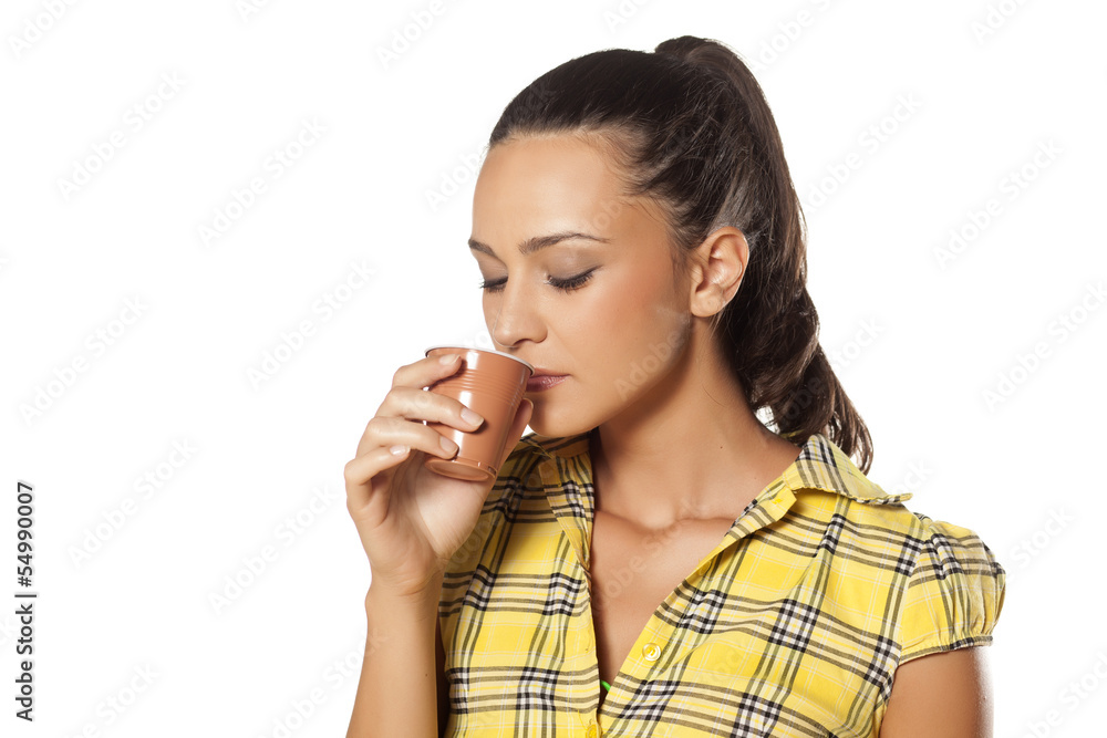 young brunette enjoys drinking her coffee from the machine young brunette enjoys drinking her coffee from the machine