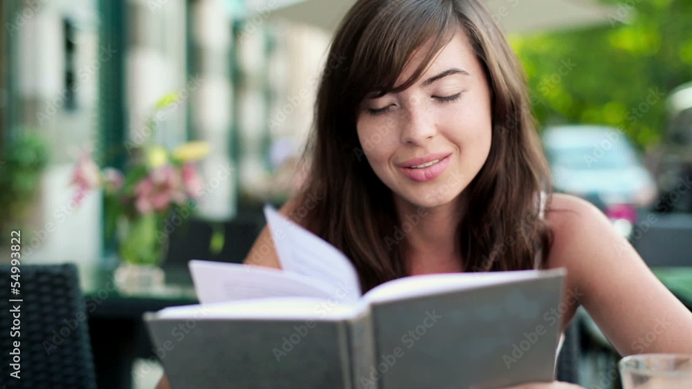 Young woman reading book and drink lemonade in cafe Young woman reading book and drink lemonade in cafe