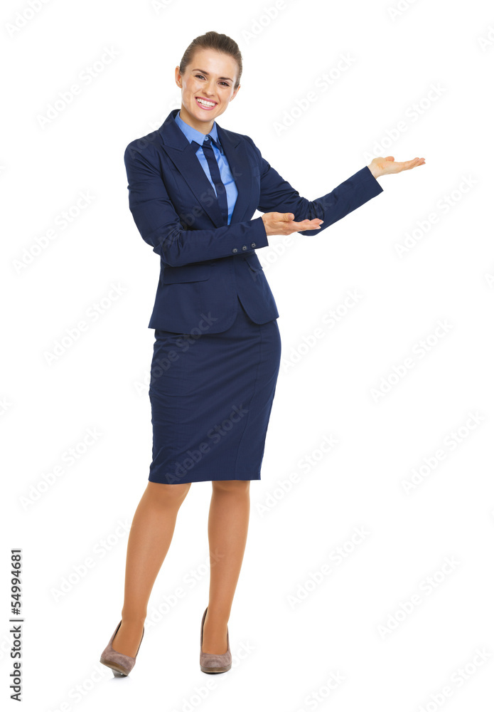 Full length portrait of happy business woman showing something Full length portrait of happy business woman showing something