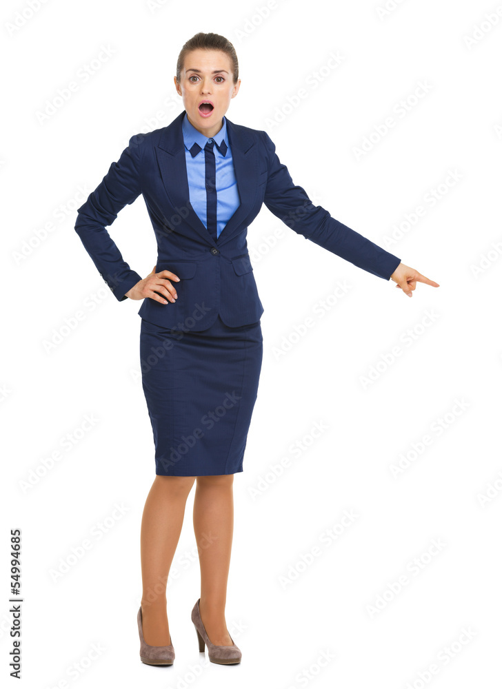 Surprised business woman pointing on copy space Surprised business woman pointing on copy space