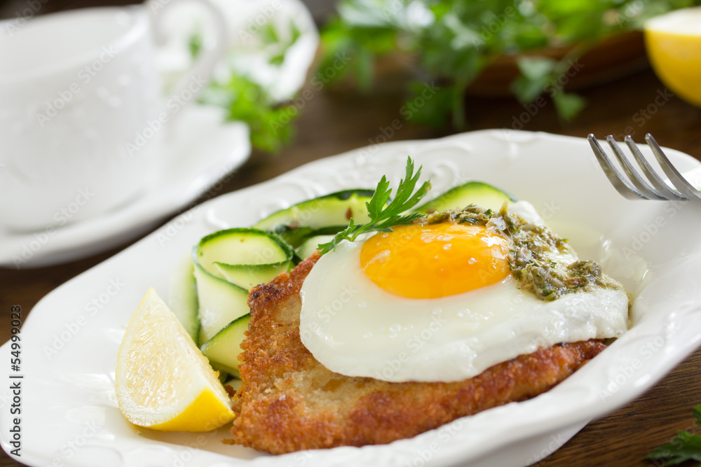 Wiener schnitzel with fried egg and capers. Wiener schnitzel with fried egg and capers.