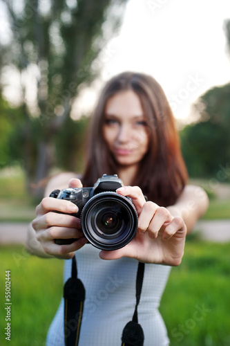 Beautiful girl with camera outdoor