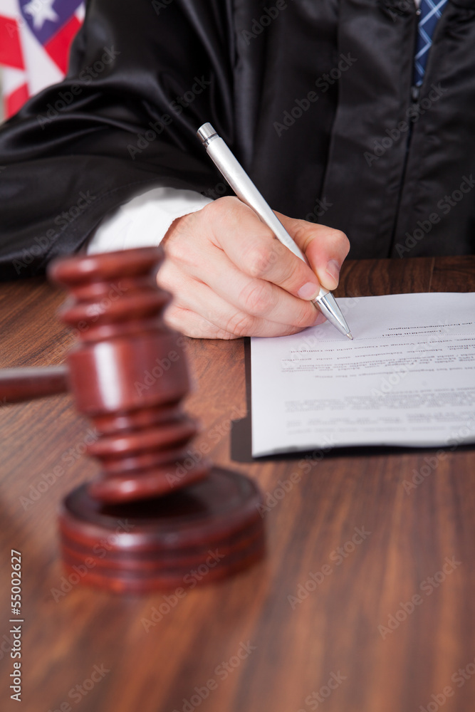 Male Judge Writing On Paper Male Judge Writing On Paper