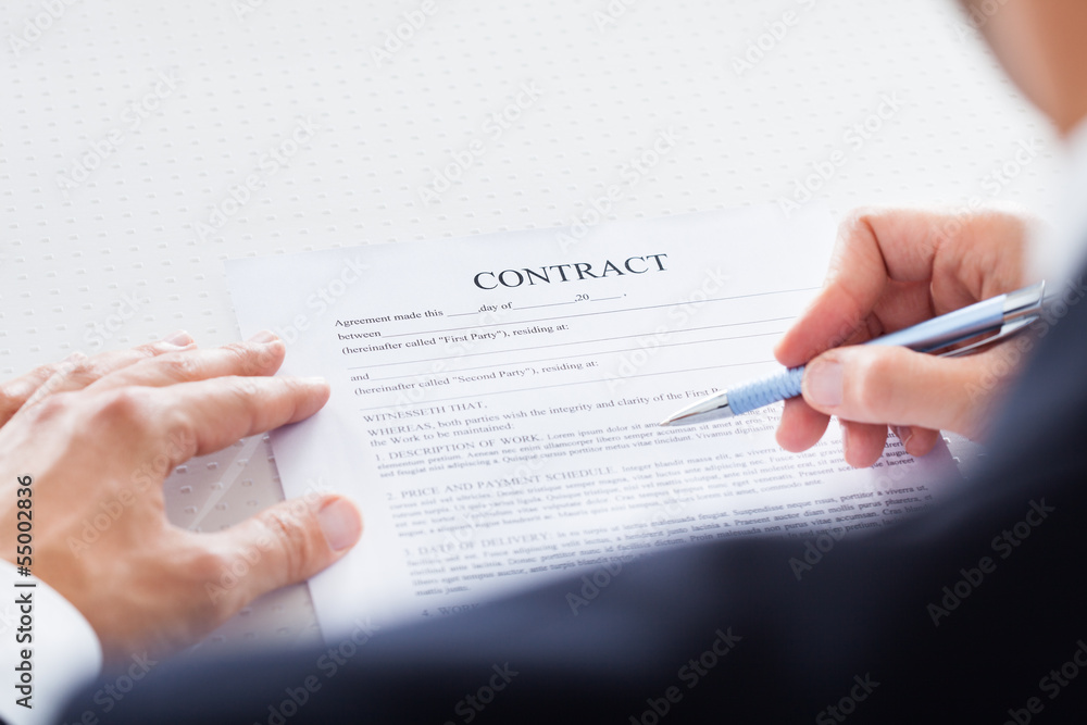 Businessman Looking At Contract Paper Businessman Looking At Contract Paper