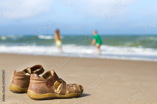 Kid sandals with blurred boy and girl
