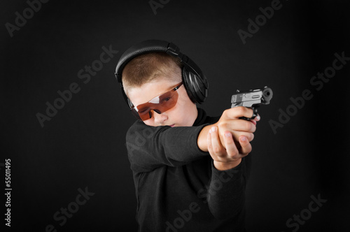 boy shoots from a gun