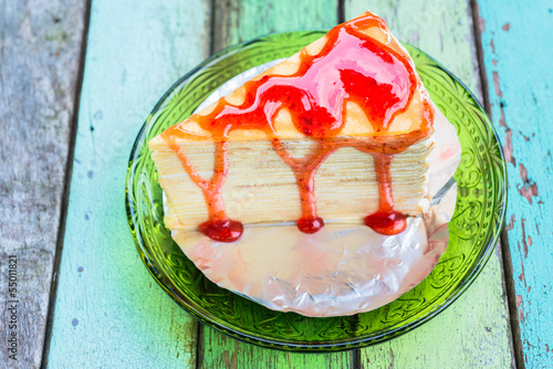 Crepe cake with strawberry sauce photo