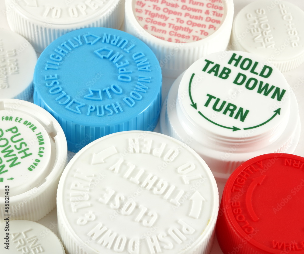 Collage of medicine bottle safety caps on a white background Collage of medicine bottle safety caps on a white background