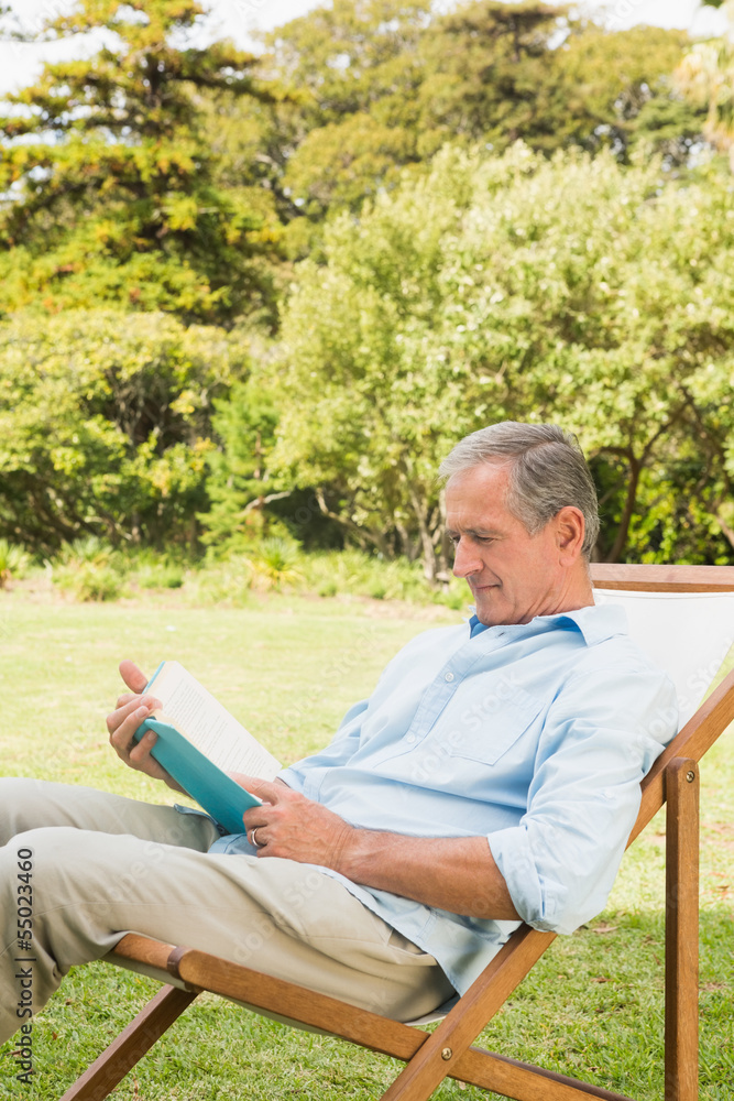 Happy mature man reading book Happy mature man reading book