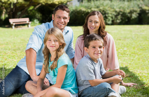 Family sitting together smiling at camera © WavebreakmediaMicro