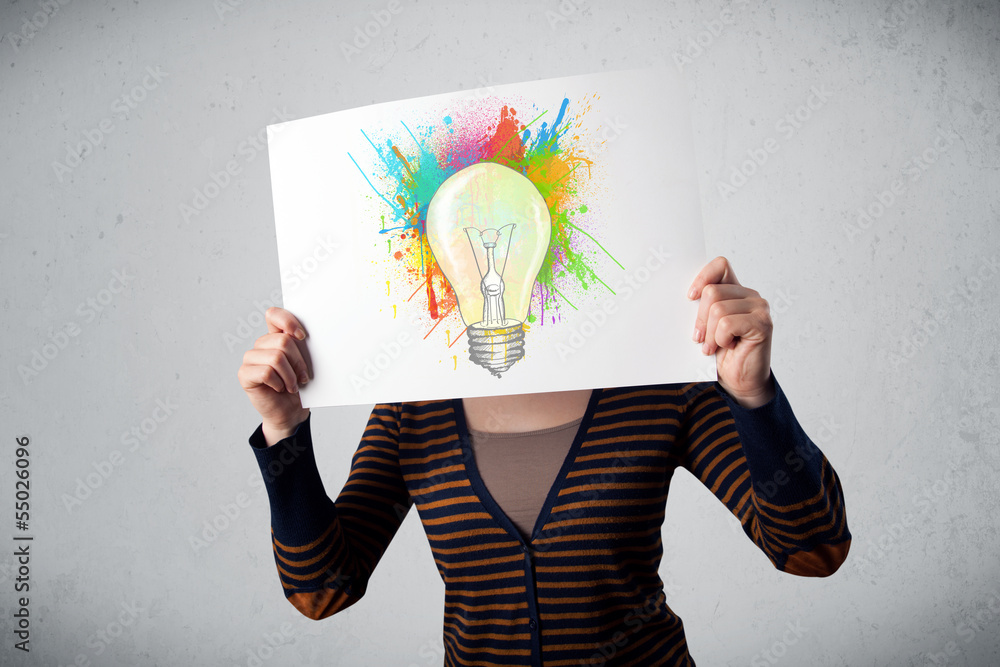 Woman holding a cardboard with paint splashes and lightbulb in f