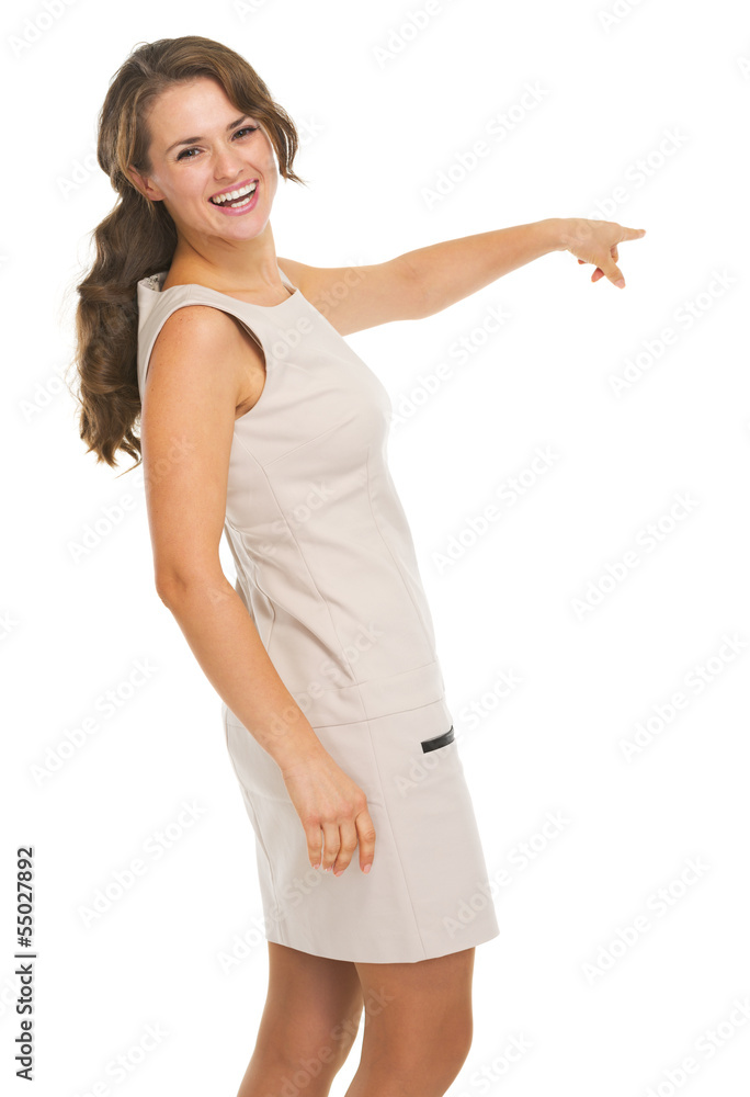 Smiling young woman pointing on copy space Smiling young woman pointing on copy space