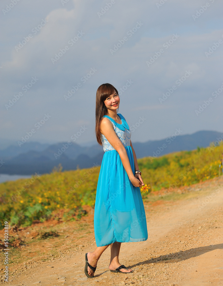 Fototapeta premium beautiful young girl in a meadow in summer