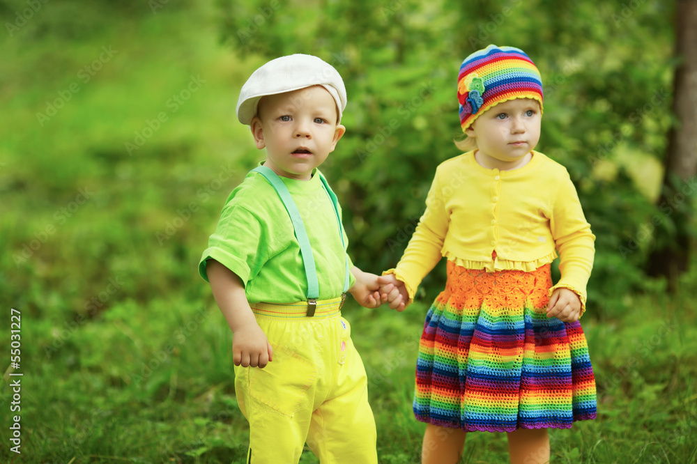 Boy with a girl in bright colored clothing Boy with a girl in bright colored clothing