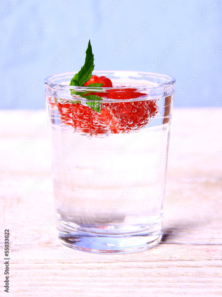 Water in glass with raspberries and mint Water in glass with raspberries and mint