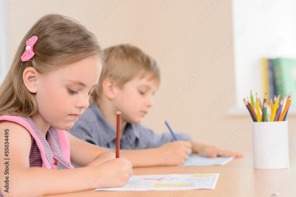 Diligent young learners. Confident pupils writing something in t Diligent young learners. Confident pupils writing something in t