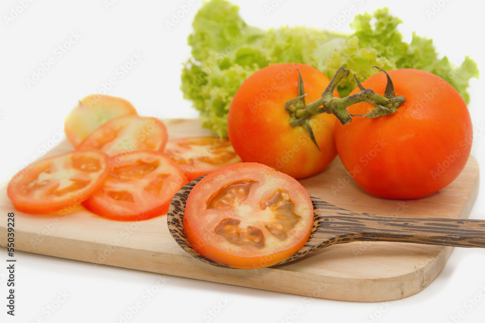 Closeup of slice tomato on Wooden Cutting Board