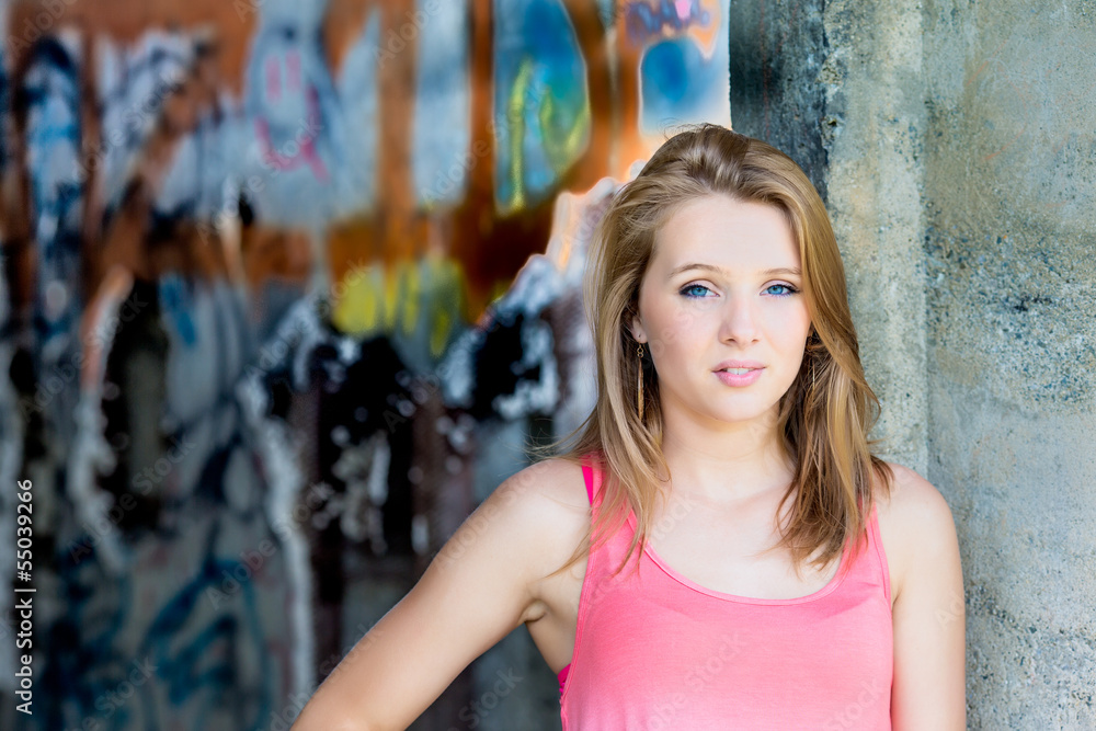 Naklejka premium Teenage Girl Graffiti wall in background