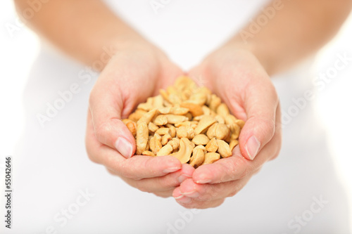 Cashew nuts - woman holding salty cashew nuts