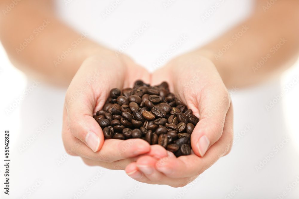 Coffee beans - woman showing coffee bean handful Coffee beans - woman showing coffee bean handful