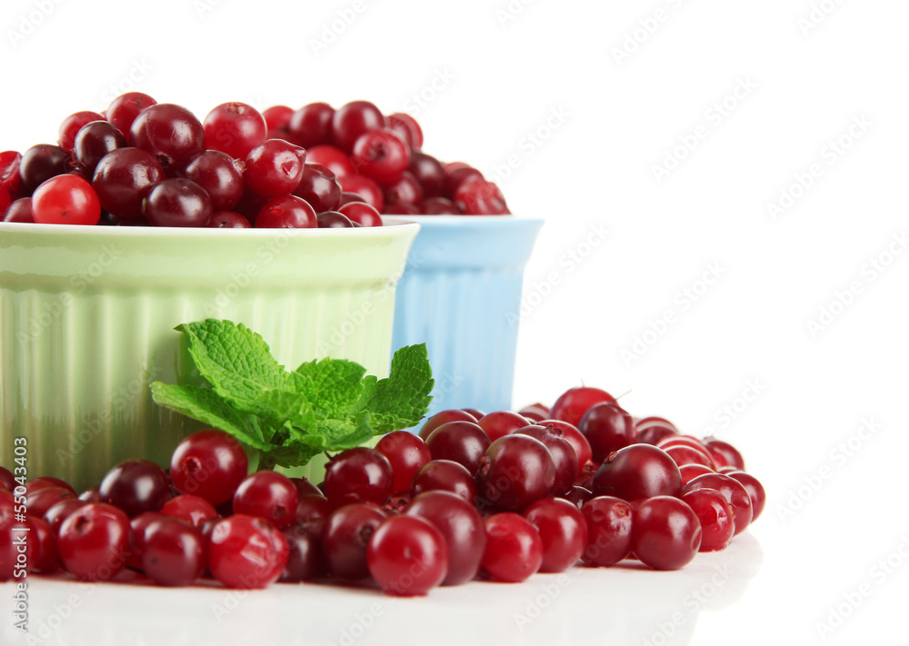 Ripe red cranberries in bowls, isolated on white. Ripe red cranberries in bowls, isolated on white.