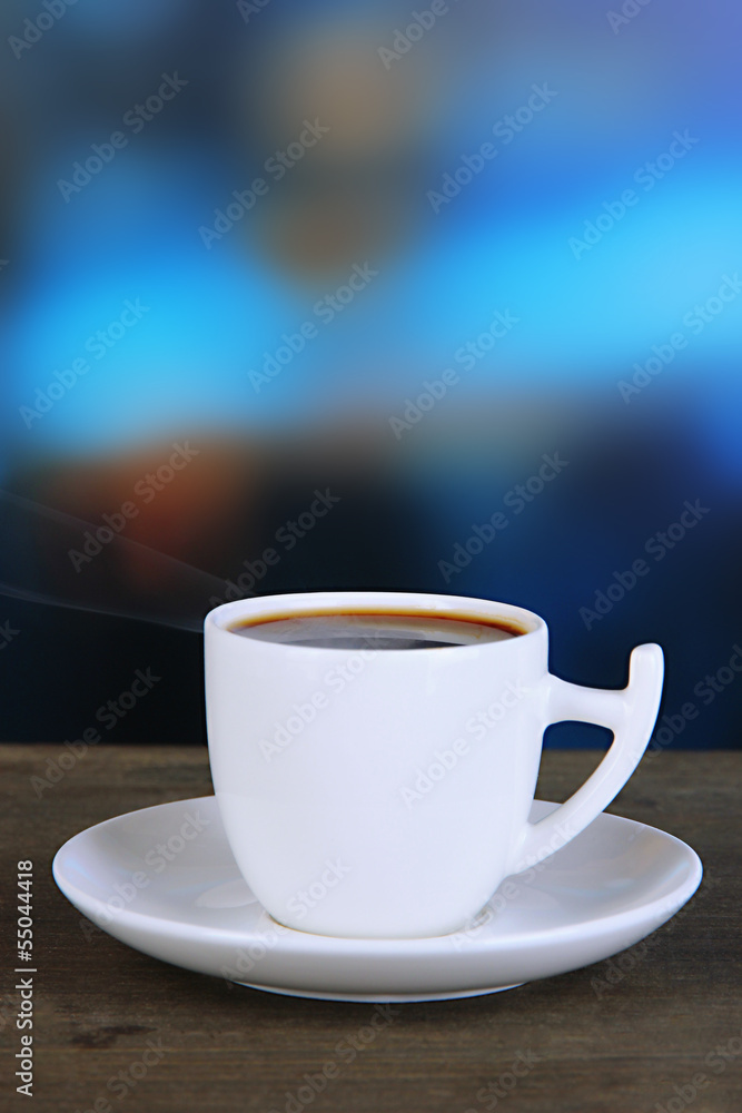 Cup of coffee on wooden table on bright background Cup of coffee on wooden table on bright background