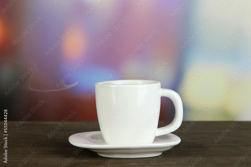 Cup of coffee on wooden table on bright background Cup of coffee on wooden table on bright background