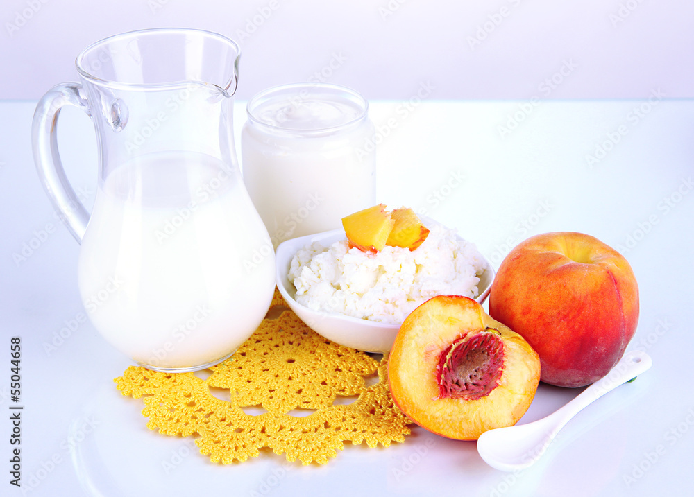 Fresh dairy products with peaches isolated on white Fresh dairy products with peaches isolated on white