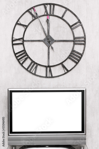 wall clock under blank white screen of TV