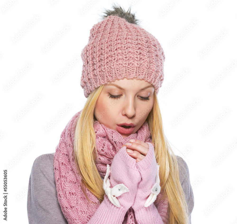 Teenager girl in winter hat and scarf warming hands Teenager girl in winter hat and scarf warming hands