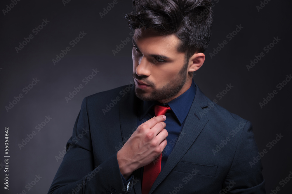 © Viorel Sima - business man fixing his tie and looking away © Viorel Sima - business man fixing his tie and looking away