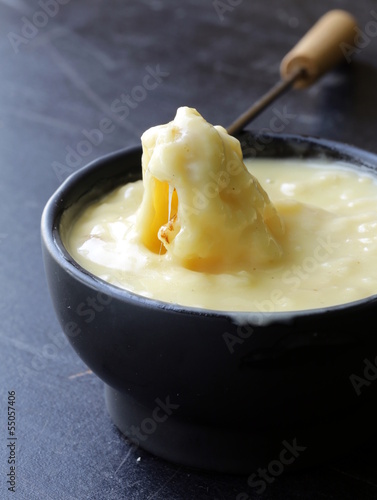 cheese fondue - piece of bread (croutons) in a liquid cheese