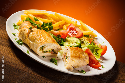 Fried wrapped meat, French fries and vegetables