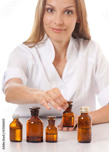 woman doctor with medication in glass bottles