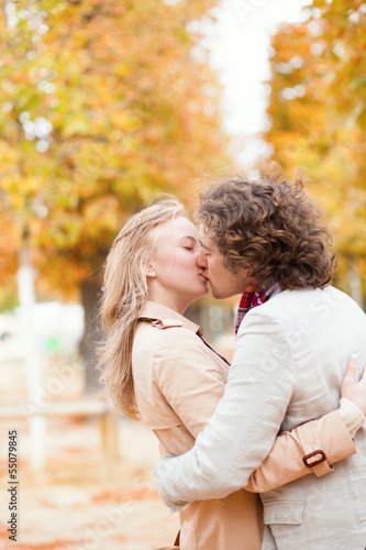 Romantic couple kissing on a fall day
