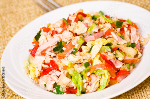fresh salad with chicken, ham and vegetables