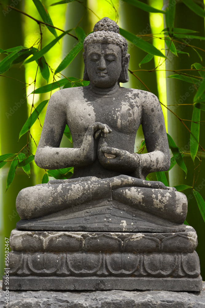 Grey Buddah with bamboo bachground StockFoto Adobe Stock