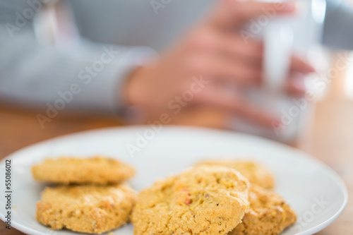 Cookies and woman holding a cup