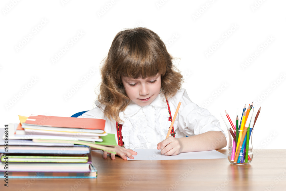 Red-haired schoolgirl at the desk Red-haired schoolgirl at the desk