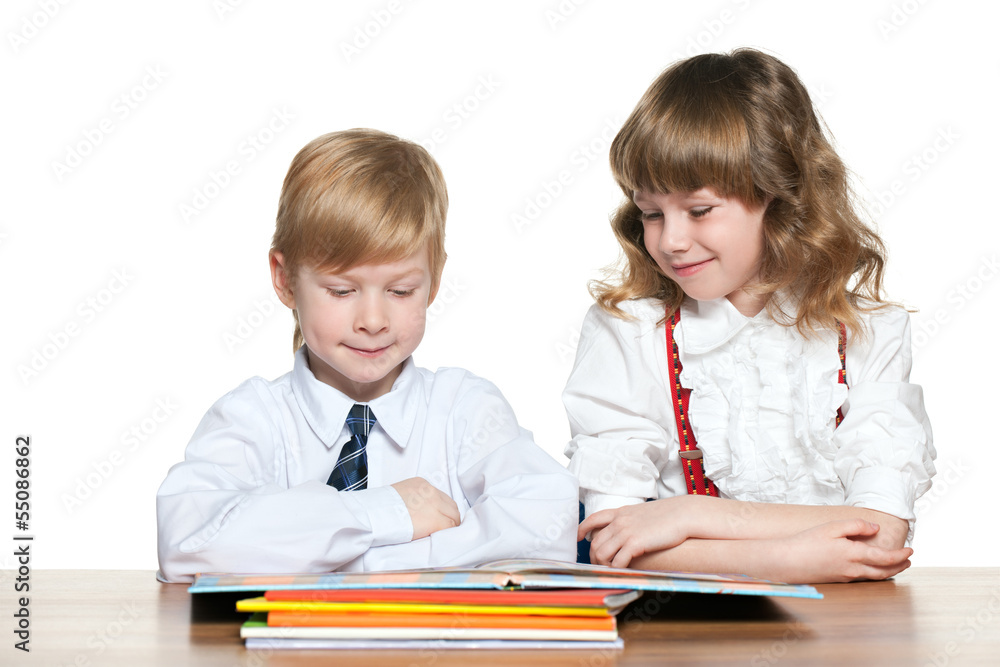 Kids are reading at the desk Kids are reading at the desk