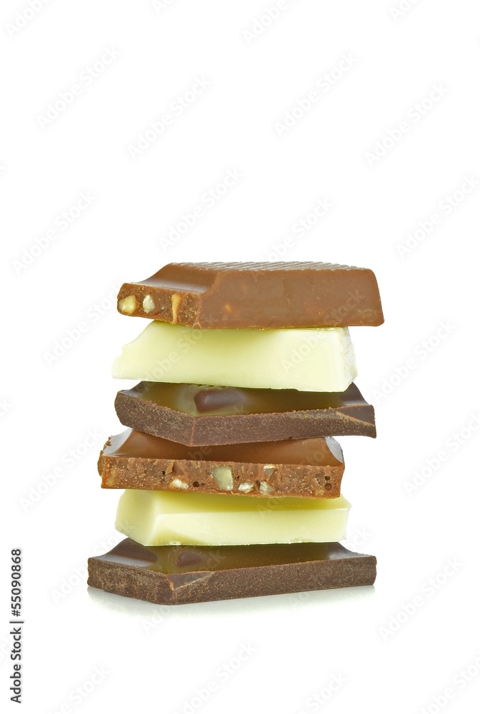 A mixed stack of chocolate chunks on a white background A mixed stack of chocolate chunks on a white background