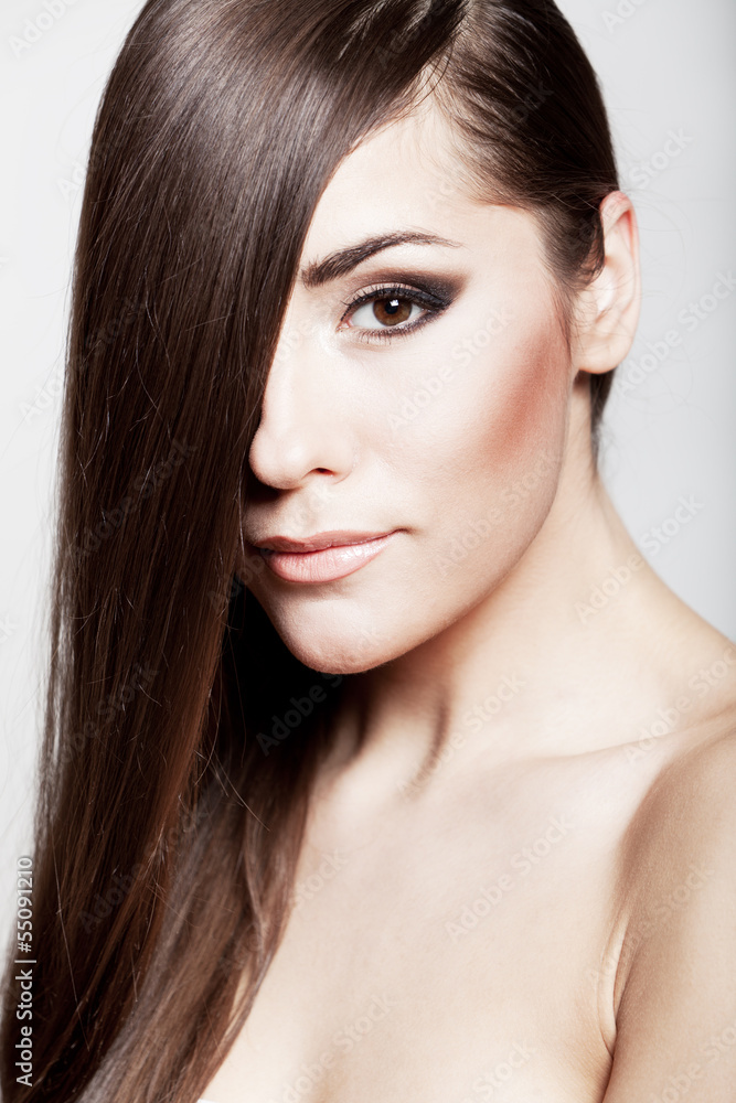 Obraz premium Beautiful young brunette woman with long hair