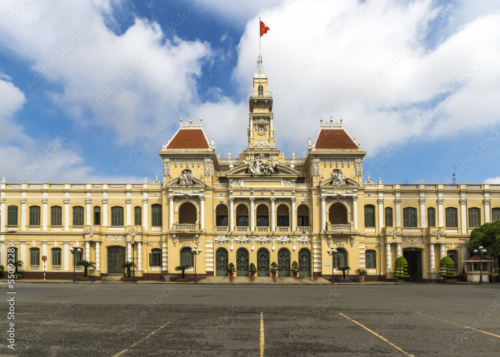 Ho Chi Minh City city hall with Vietnamese flag on top.