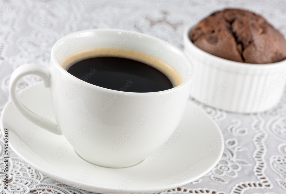Coffee cup and chocolate muffin on the table Coffee cup and chocolate muffin on the table