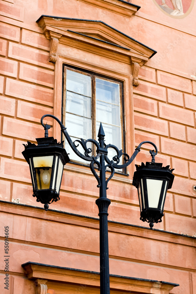 Refurbished fragment of ancient buildings in Warsaw and lantern Refurbished fragment of ancient buildings in Warsaw and lantern